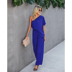 Royal blue one-shoulder wide-leg jumpsuit with elastic waist in an outdoor setting