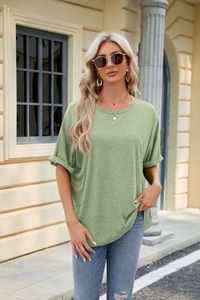Close-up of sage green crew neck tee with rolled cuffs and soft cotton texture