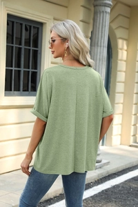 Detail of sage green T-shirt showing back vertical seam and rolled cuff design