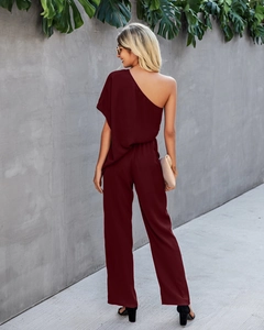 Rear view of deep red one-shoulder jumpsuit with wide legs and asymmetrical high waist cut