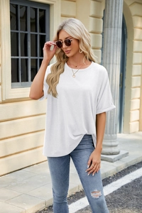 Detailed view of white crewneck t-shirt cuff with rolled edge and clean cotton texture