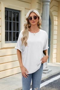 Detail of white cotton t-shirt featuring rolled cuffs and a relaxed crew neck style