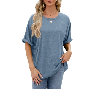 Women's oversized blue round neck T-shirt with rolled sleeves and denim jeans