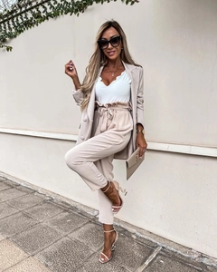 Detailed view of beige business suit set with high waist tie pants and matching blazer