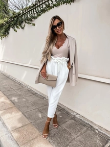 Outdoor shot of stylish high waist beige cropped trousers with drawstring and soft fabric