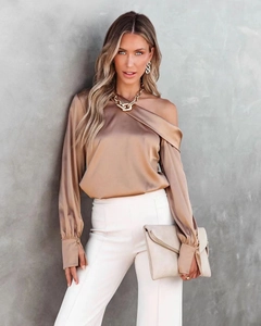 Detail of elegant champagne satin off-shoulder blouse featuring lantern sleeves and buttons
