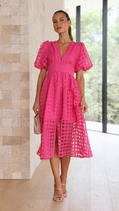 Detail of hot pink V-neck dress featuring unique hollow checkered texture and lantern sleeves