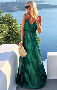 Detail of emerald green pleated maxi dress with satin texture and waist tie design