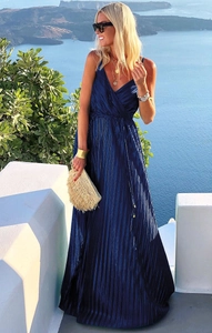 Detail of deep blue pleated maxi dress featuring a V-neckline and elegant satin sheen