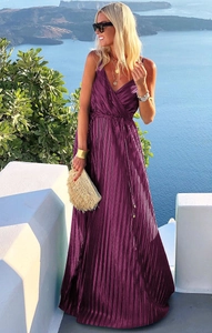Detail of elegant pleated deep purple maxi dress with wrap V-neck and resort style vibes