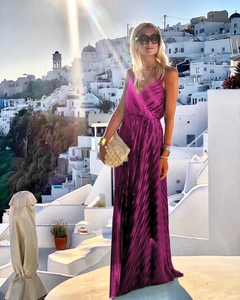 Detail of elegant pleated rose red maxi dress with thin straps for a summer vacation look