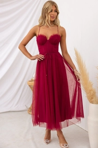 Detail of burgundy spaghetti strap midi dress with corset-style bodice and tulle skirt