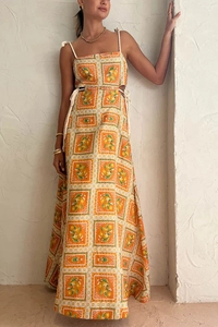 Detail of waist cut-out and drawstring knot on lemon print summer maxi dress