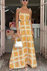 Detail of orange lemon print dress featuring side waist cutouts and rope shoulder straps