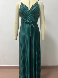 Detail view of dark green pleated maxi dress with elegant V-neckline and tie waist belt