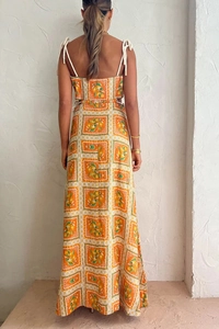 Detail of orange summer dress with lemon print, backless cutout and rope shoulder straps