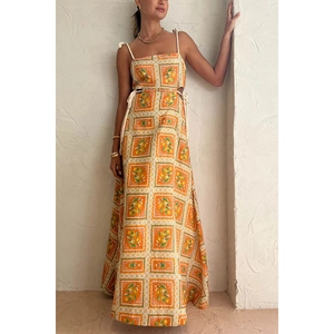 Bright orange long summer dress with white grids and lemon print, side cutouts and tie straps