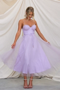 Detail of light purple tulle midi dress featuring ruffled bodice and waist tie belt