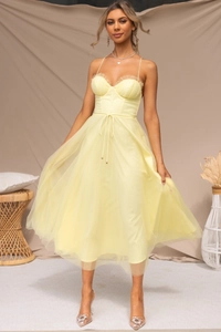Detail of the boned corset bodice and ruffled mesh fabric on this pale yellow summer dress