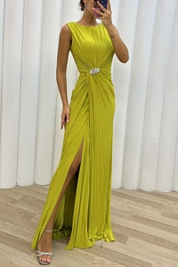 Detail of lime yellow pleated sleeveless dress featuring a waist rhinestone buckle and high slit