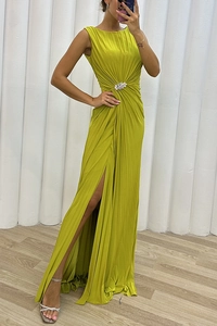 Detail of waist rhinestone floral brooch on pleated sleeveless lime green evening gown