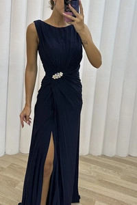 Detailed view of navy blue pleated dress featuring luxury crystal waist embellishment
