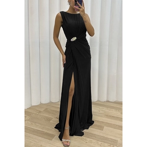 Elegant black sleeveless pleated maxi dress with rhinestone brooch and high slit