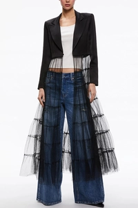Detail of elegant black satin blazer dress with multi-layered sheer tulle skirt patchwork
