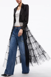Detail of a chic black blazer dress with tiered long tulle skirt and stylish lapel collar