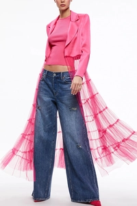 Detail view of pink satin blazer with layered tulle skirt overlay and distressed blue jeans