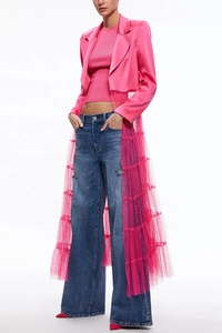 Detailed view of hot pink satin blazer with layered tulle train and wide-leg denim jeans