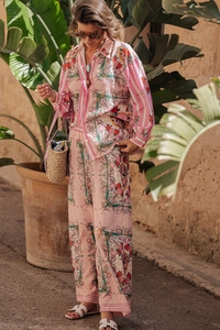 Detail of pink baroque print lounge set featuring long-sleeved shirt and wide-leg pants