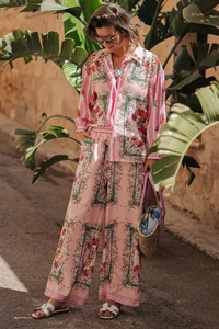 Detail of bohemian floral print two-piece set featuring long sleeve shirt and wide leg pants