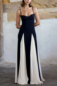 Detail view of contrast black and white strap dress with pleated patchwork hem design