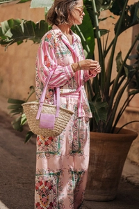 Detail of pink floral pajama set with baroque patterns and striped trim details