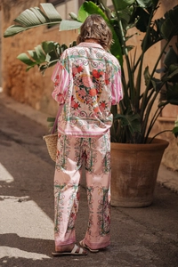 Outdoor back view of bohemian pink floral print shirt and trousers set with rose pattern