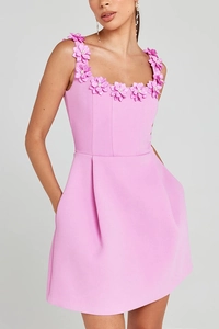 Close-up of pink 3D flower appliques with bead centers on the sleeveless dress neckline