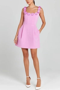 Detail of pink A-line mini dress featuring 3D floral appliques and side pockets