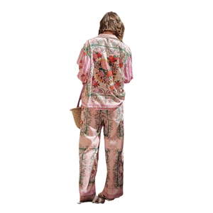 Women's two-piece pink satin pajama set with floral rose patterns and long sleeves