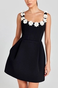 Detail of white 3D floral appliqués on black sleeveless dress neckline