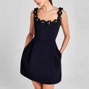 Chic black sleeveless mini dress with 3D floral pearl accents and practical side pockets