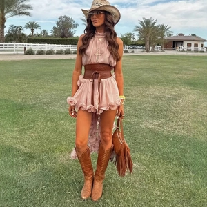 Pink ruffle sleeveless dress set with wide belt and western boots in outdoor setting