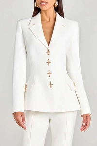 Detail of elegant gold star buckles on the white blazer jacket and pocket flaps