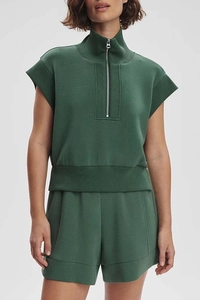 Detail of dark green two-piece lounge set featuring half-zip short sleeve sweatshirt