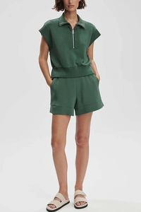 Detail view of dark green short sleeve hoodie and wide-leg shorts with zipper detail