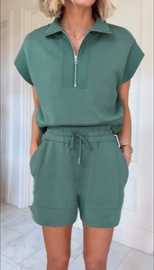 Detail of dark green two-piece lounge set with half-zip top and drawstring shorts