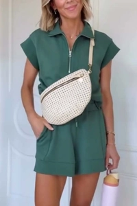Detail of dark green short sleeve romper featuring front zipper and lapel collar design