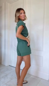 Detail of dark green two-piece casual set featuring short sleeve top and elastic shorts