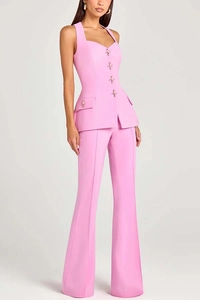 Detail view of pink women's suit with heart neckline and decorative gold star buttons