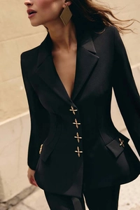 Detail of tailored black suit blazer featuring decorative golden cross metal buttons